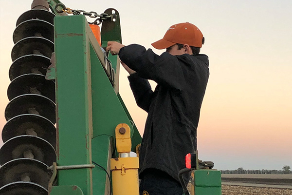 Hardworking young man putting his hands on the equipment
